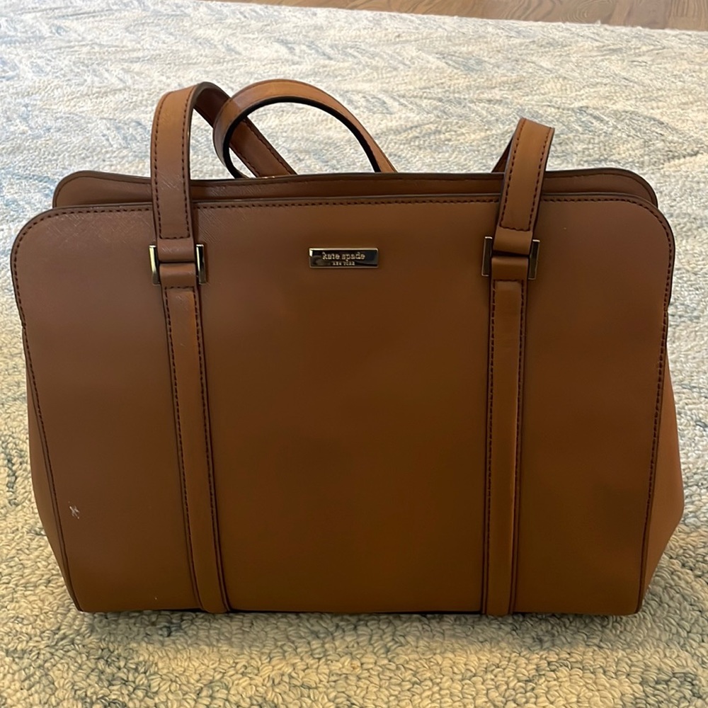 Kate Spade brown leather tote bag with gold accents. Multiple interior pockets